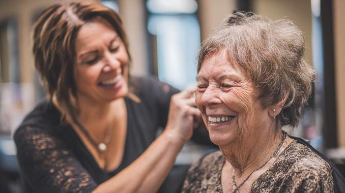 Compassionate mobile stylist providing gentle haircut for elderly resident